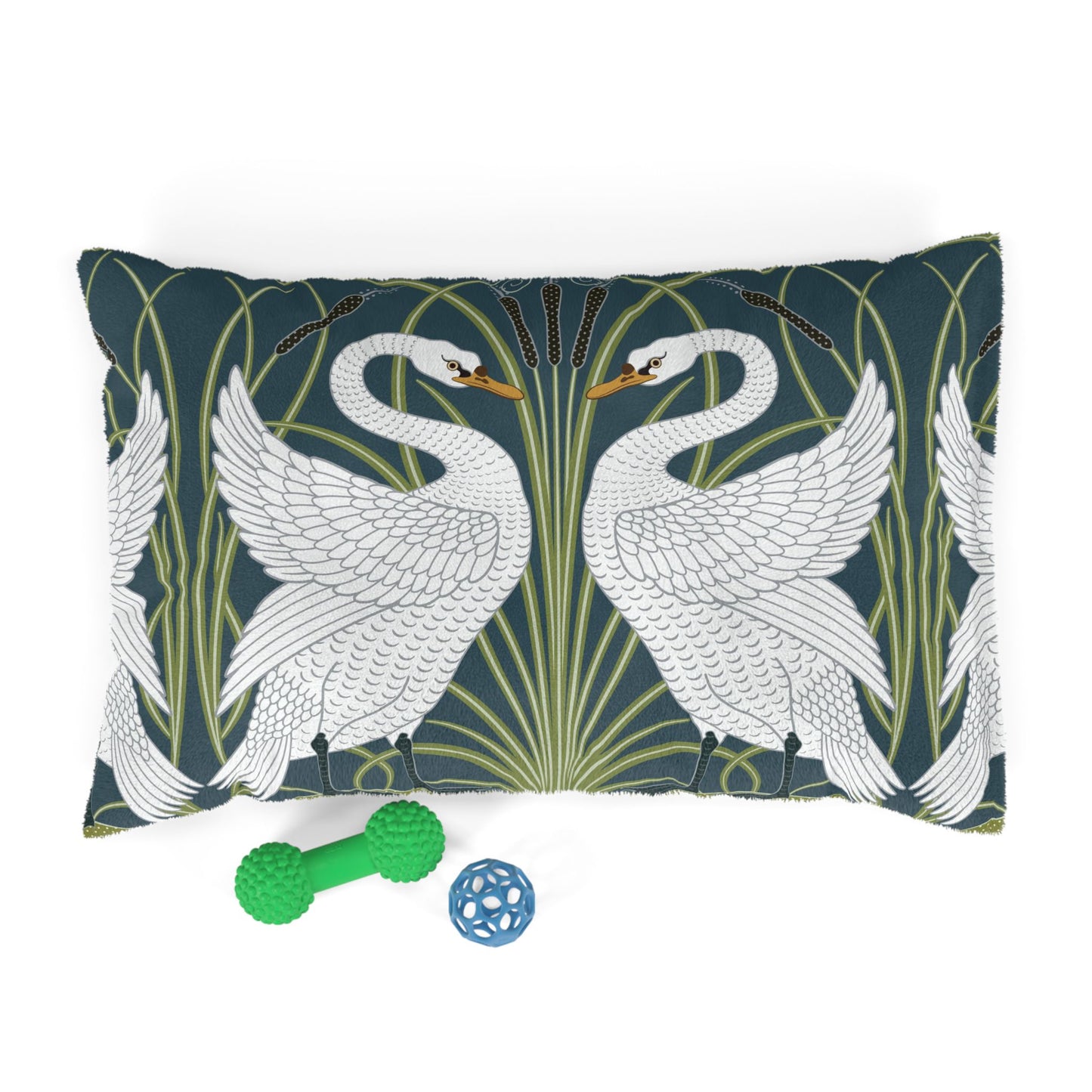 Decorative William Morris & Co pillow with swan design and two pet toys on a white background