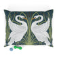 Decorative pillow with swan design on a dark green background