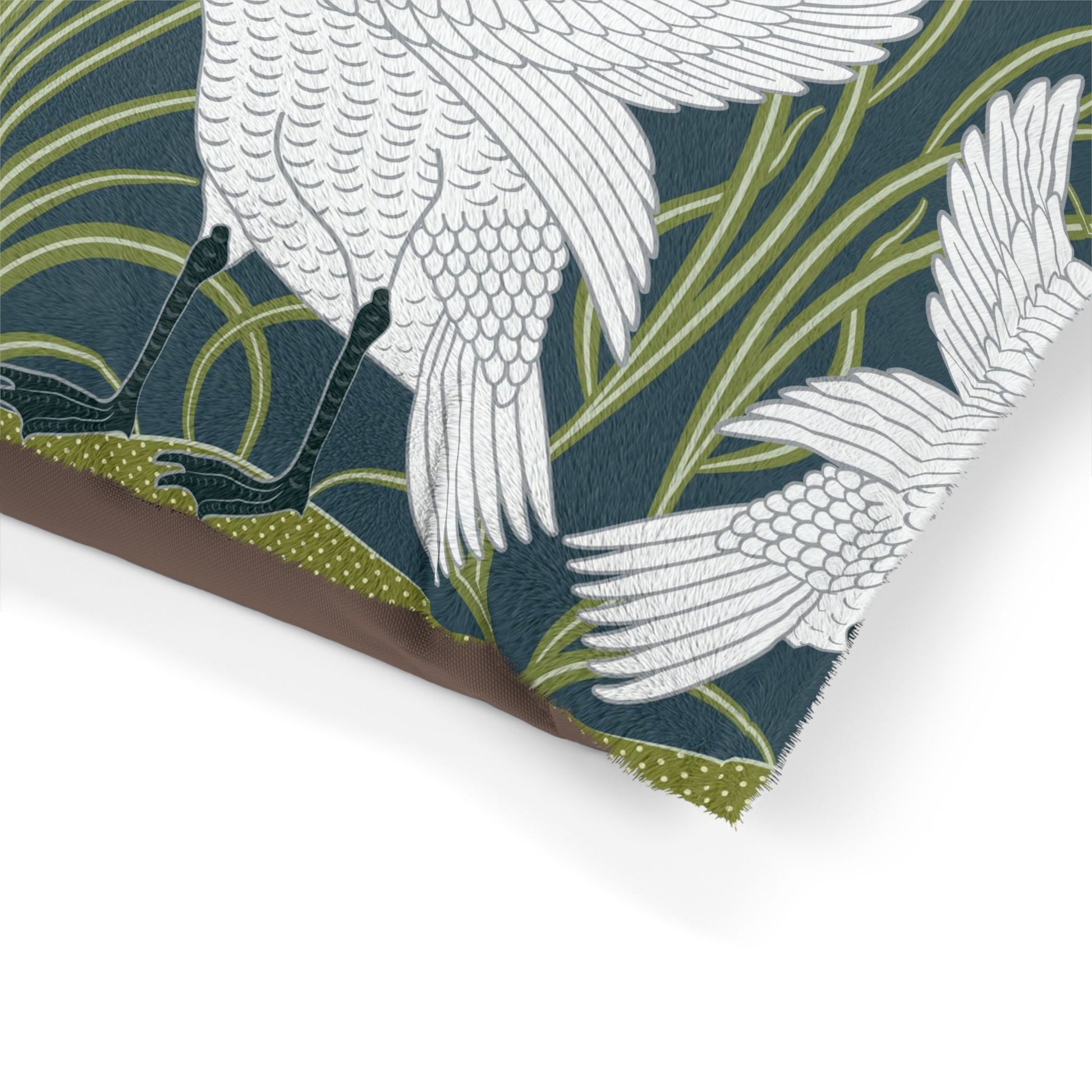 Close-up of a fabric with white bird design on a dark blue background