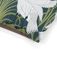 Close-up of a fabric with white bird and green leaf pattern on a dark blue background