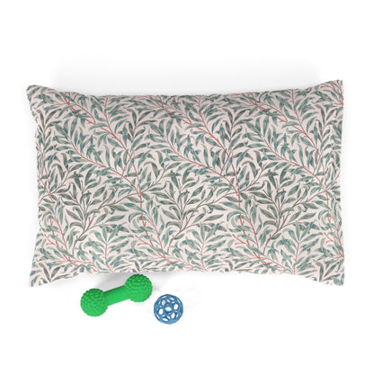 Floral-patterned pet bed with a green bone-shaped toy and a blue ball on a white background