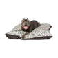 Dog lying on a leaf-patterned pet bed with a white background