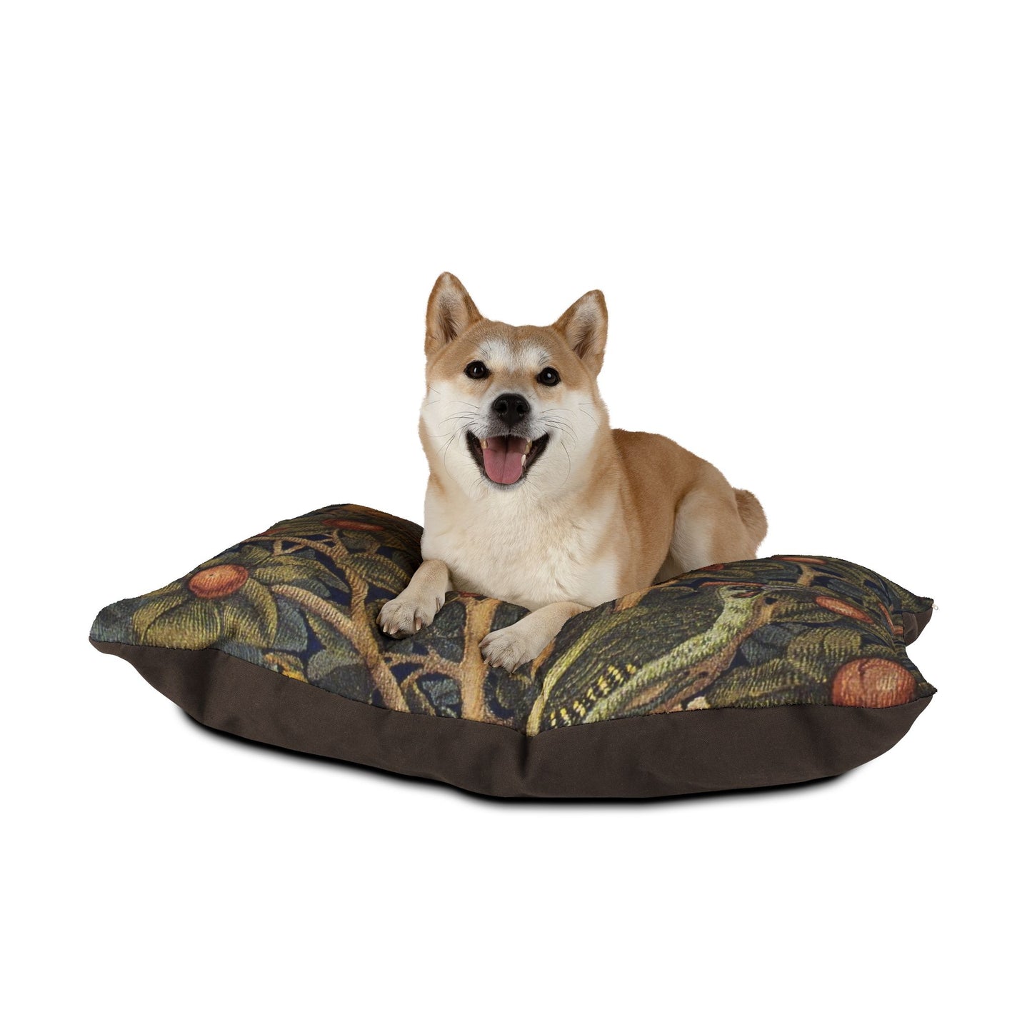 Dog sitting on a decorative dog bed with a William Morris & Co nature-themed pattern on a white background