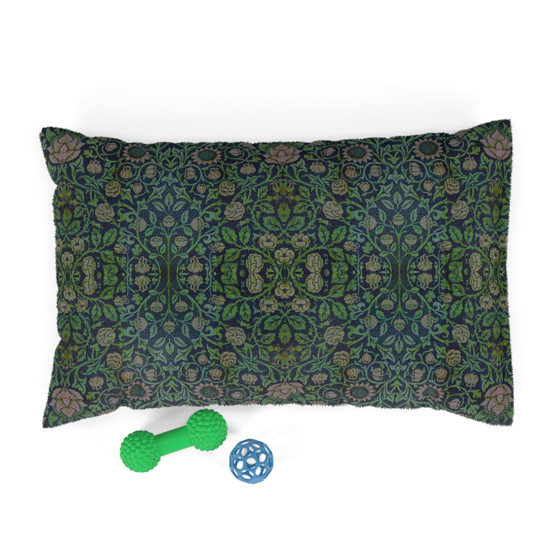 Decorative dog pillow with William Morris & Co floral pattern and two pet toys on a white background