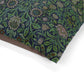 Floral patterned dog bed with William Morris & Co green and blue colours on a white background