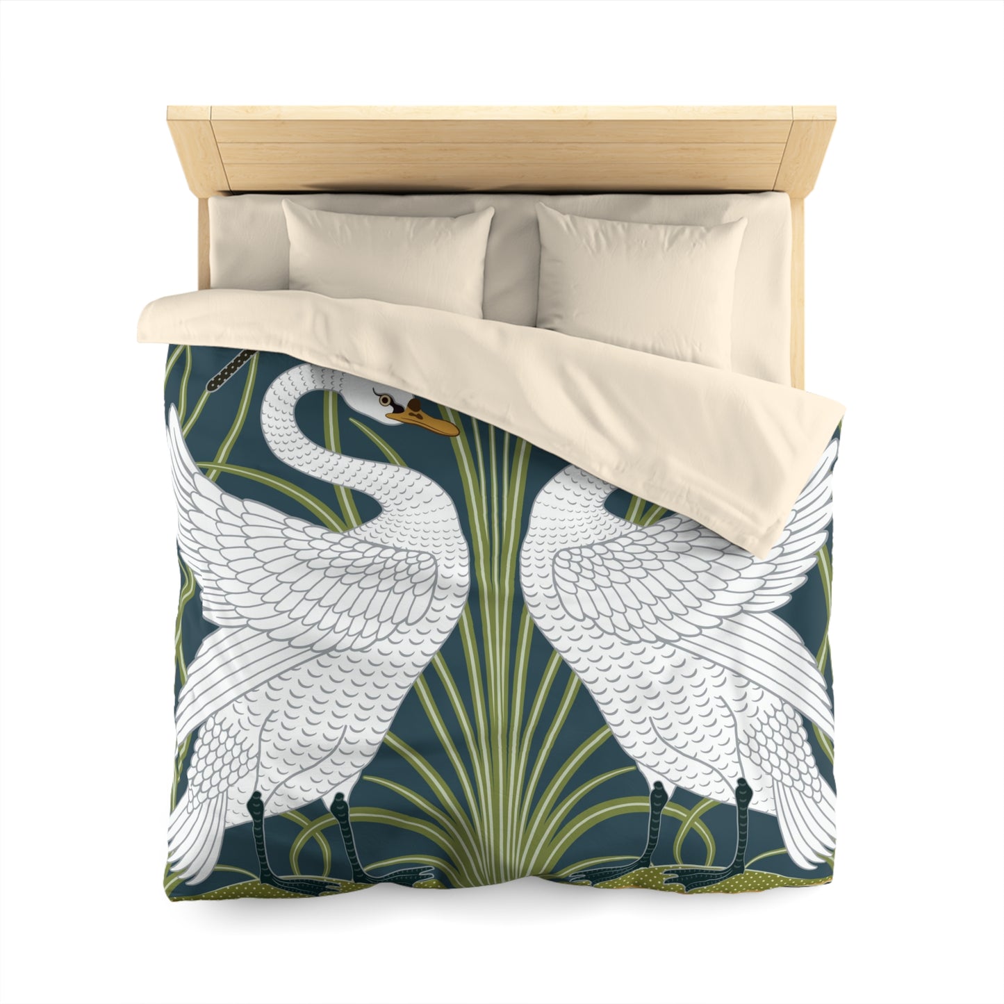 A duvet cover with a William Morris & Co pattern floral and swan pattern, displayed on a bed with pillows.