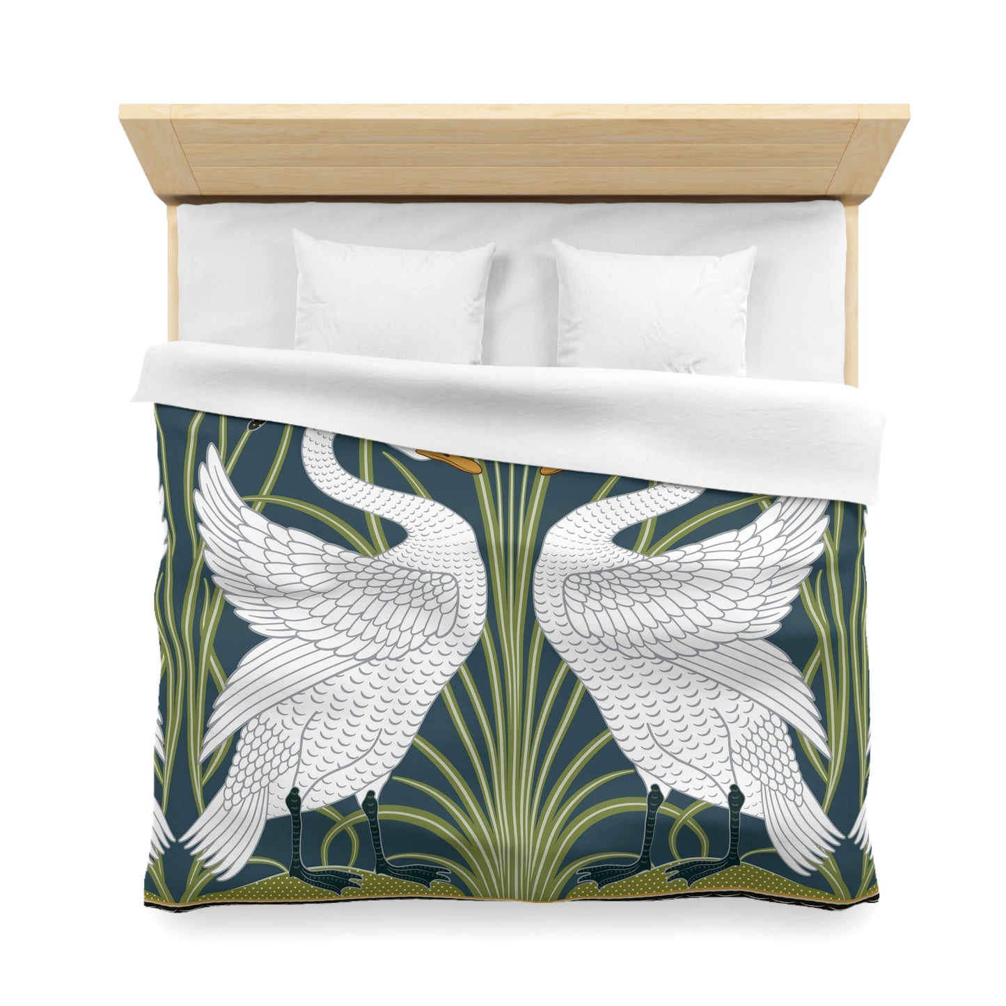 A duvet cover with a William Morris & Co pattern floral and swan pattern, displayed on a bed with pillows.