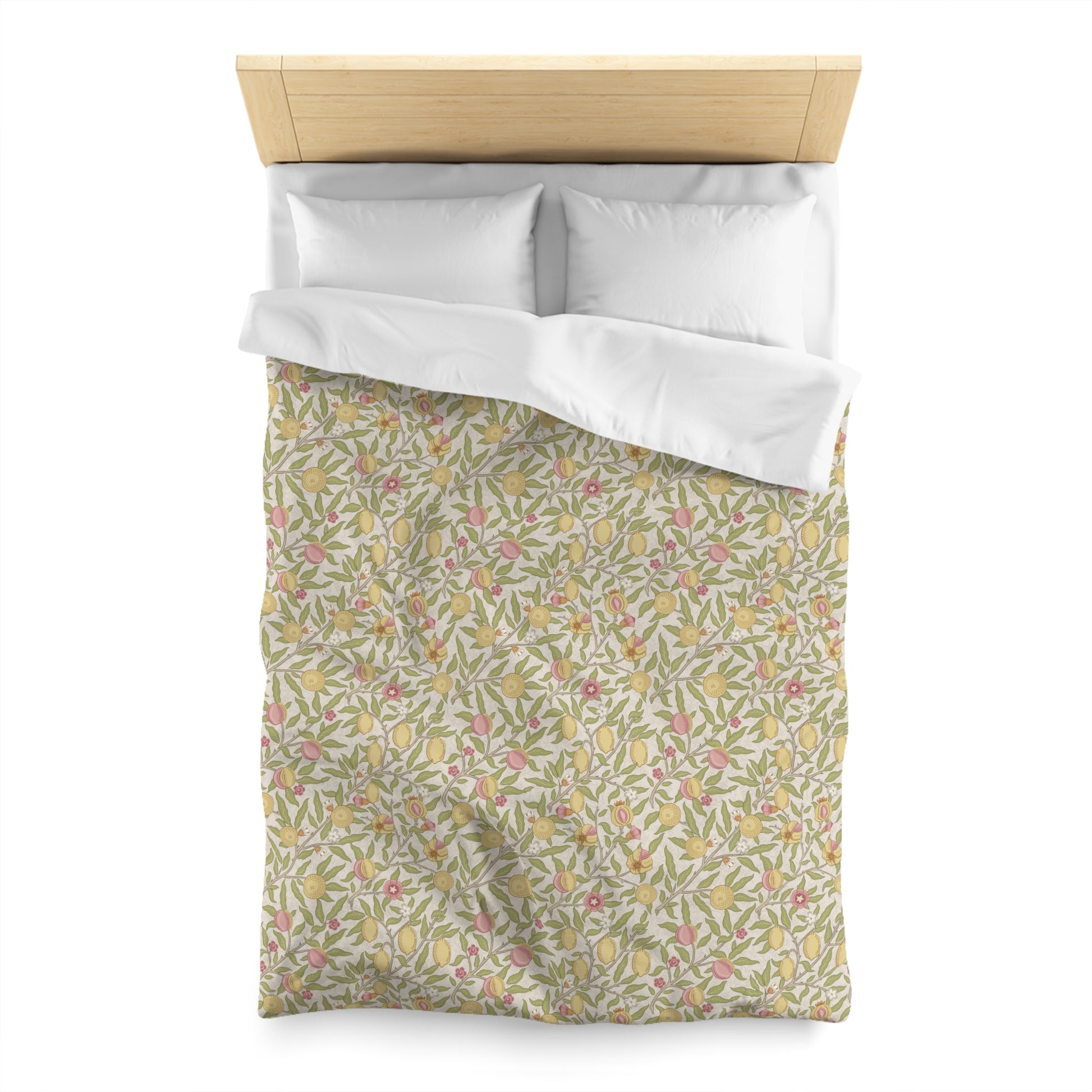 Floral patterned duvet cover with white pillowshams on a bed.