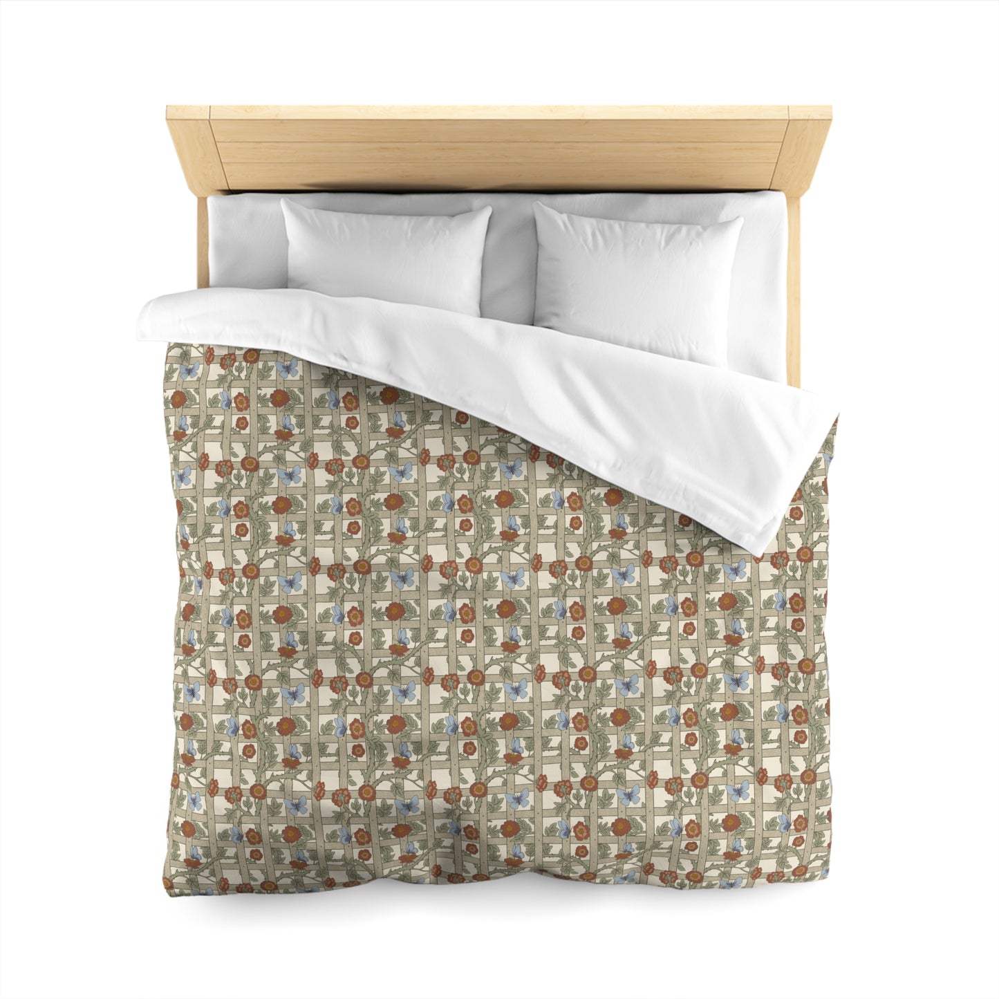 Bed with patterned duvet cover and white pillows on a white background