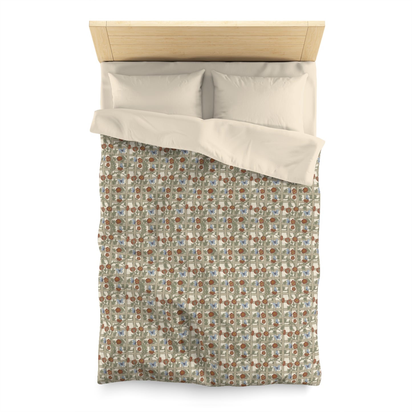 Patterned duvet cover with beige pillow shams on a bed with wooden headboard.