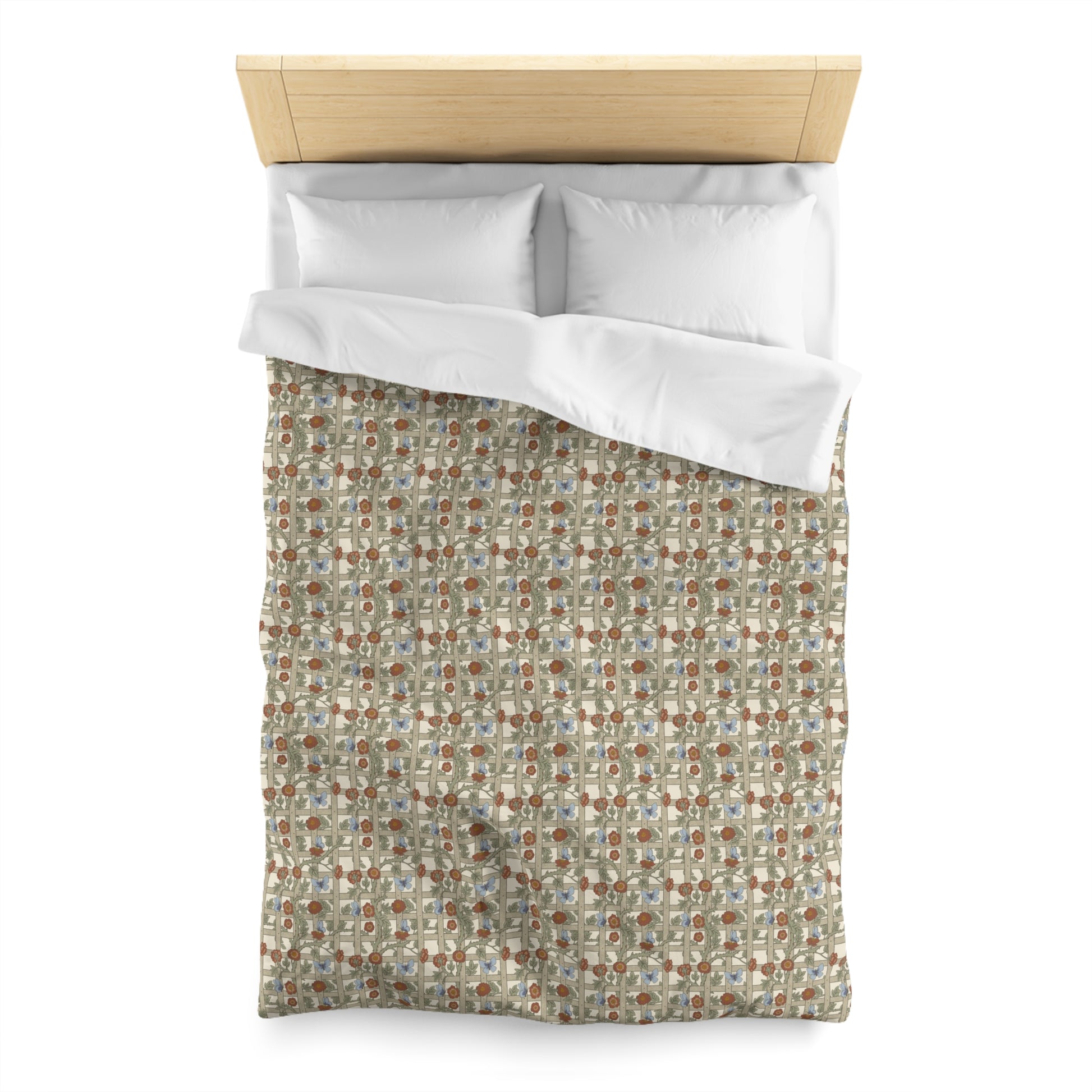 Floral patterned duvet cover with white pillowshams on a bed.