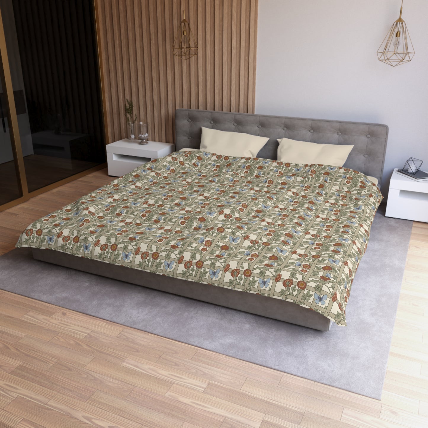 Bedroom with a bed featuring a patterned comforter on a wooden floor.