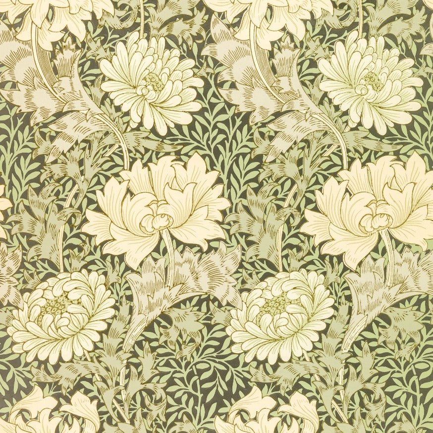 A repeating floral pattern featuring large cream-colored flowers and leafy stems on a dark olive green background, with a classic Arts and Crafts style.
