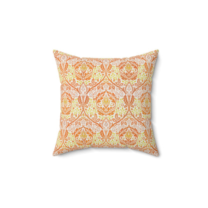 A square-shaped cushion with a geometric William Morris & Co pattern featuring orange and yellow hues on a white background.