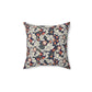 A square-shaped cushion with a William Morris & Co floral pattern called Leicester featuring red, blue and green colours on a white background.