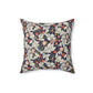 A square-shaped cushion with a William Morris & Co floral pattern called Leicester featuring red, blue and green colours on a white background.