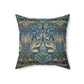 A square-shaped throw pillow with a  William Morris & Co floral and peacock design on a dark blue background with a visible concealed zipper.