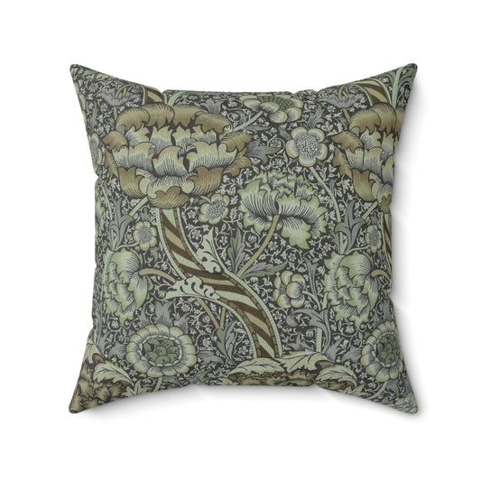 A square-shaped faux suede cushion with a William Morris & Co floral pattern in shades of gray and green called Wandle.