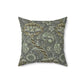 A square-shaped faux suede cushion with a William Morris & Co floral pattern in shades of gray and green called Wandle.