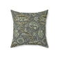 A square-shaped faux suede cushion with a William Morris & Co floral pattern in shades of gray and green called Wandle.
