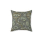 A square-shaped faux suede cushion with a William Morris & Co floral pattern in shades of gray and green called Wandle.
