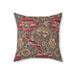 A square-shaped cushion with a floral William Morris & Co pattern called Wandle in red, beige, and darker shades of red on a darker background.