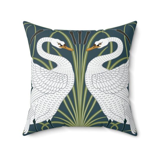 A square-shaped throw pillow with a William Morris & Co design of white swans on a green and blue patterned background.
