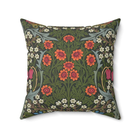 A square-shaped faux suede cushion with a floral pattern inspired by William Morris, featuring a green background with red and white flowers.