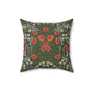 A square-shaped faux suede cushion with a floral pattern inspired by William Morris, featuring a green background with red and white flowers.