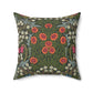 A square-shaped faux suede cushion with a floral pattern inspired by William Morris, featuring a green background with red and white flowers.
