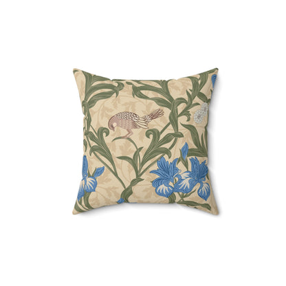 A square-shaped throw pillow with an all-over print featuring a bird, floral William Morris & Co patterns, and blue irises on a beige background.