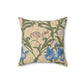 A square-shaped throw pillow with an all-over print featuring a bird, floral William Morris & Co patterns, and blue irises on a beige background.