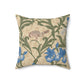 A square-shaped throw pillow with an all-over print featuring a bird, floral William Morris & Co patterns, and blue irises on a beige background.