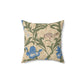 A square-shaped throw pillow with an all-over print featuring a bird, floral William Morris & Co patterns, and blue irises on a beige background.