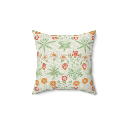 A square faux suede cushion with a floral pattern in shades of green, orange, and pink.