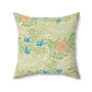 A square-shaped faux suede cushion with an all-over print featuring a William Morris & Co floral pattern in shades of green, blue, and orange.