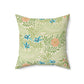 A square-shaped faux suede cushion with an all-over print featuring a William Morris & Co floral pattern in shades of green, blue, and orange.