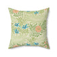A square-shaped faux suede cushion with an all-over print featuring a William Morris & Co floral pattern in shades of green, blue, and orange.