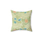 A square-shaped faux suede cushion with an all-over print featuring a William Morris & Co floral pattern in shades of green, blue, and orange.