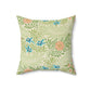 A square-shaped faux suede cushion with an all-over print featuring a William Morris & Co floral pattern in shades of green, blue, and orange.