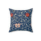A square-shaped faux suede cushion with a floral pattern inspired by William Morris, predominantly in blue with red and white accents.