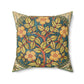 A square faux suede cushion with a floral design in green, yellow, and red.