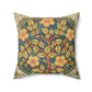 A square faux suede cushion with a William Morris & Co floral design in green, yellow and red.