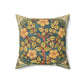 A square faux suede cushion with a William Morris & Co floral design in green, yellow and red.