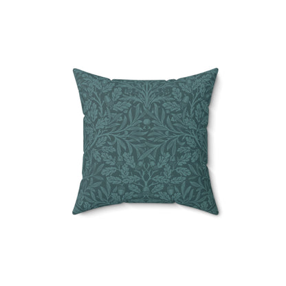 A square-shaped throw pillow with a teal colour, featuring a floral pattern of acorns and oak leaves inspired by William Morris.