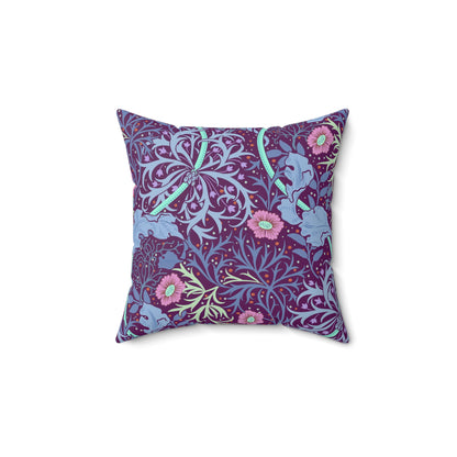 A square faux suede cushion with a floral William Morris & Co pattern in pink, green, and purple colours called Seaweed.