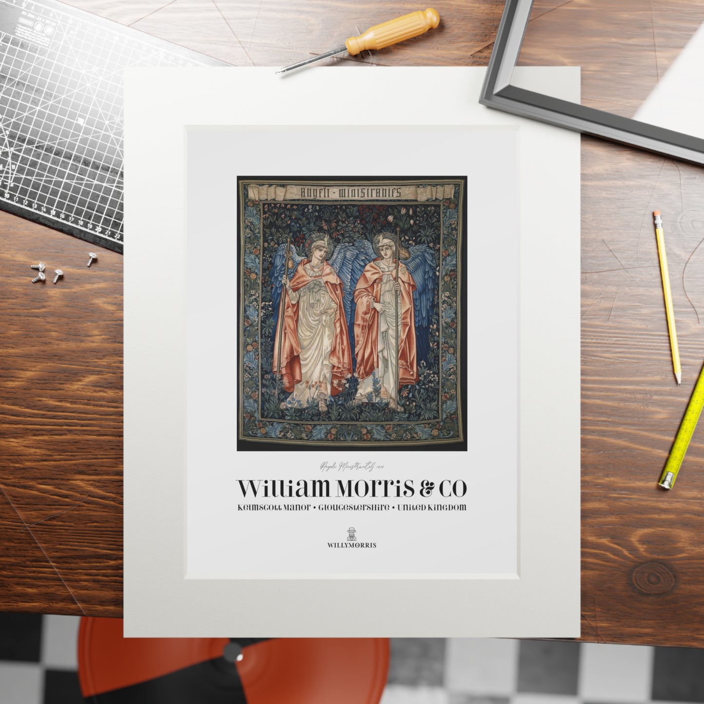 Framed artwork with 'William Morris & Co' branding on a wooden table.