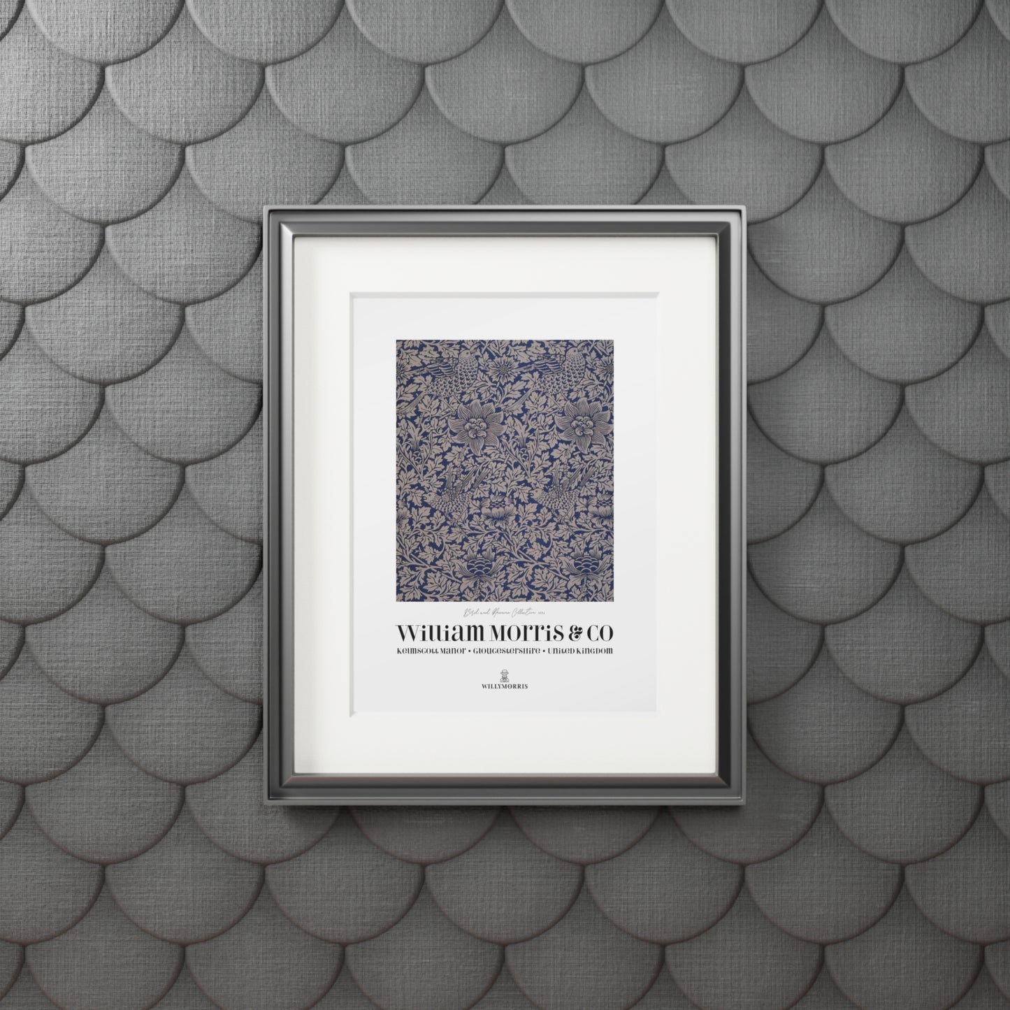 Framed artwork with text on a textured gray wall