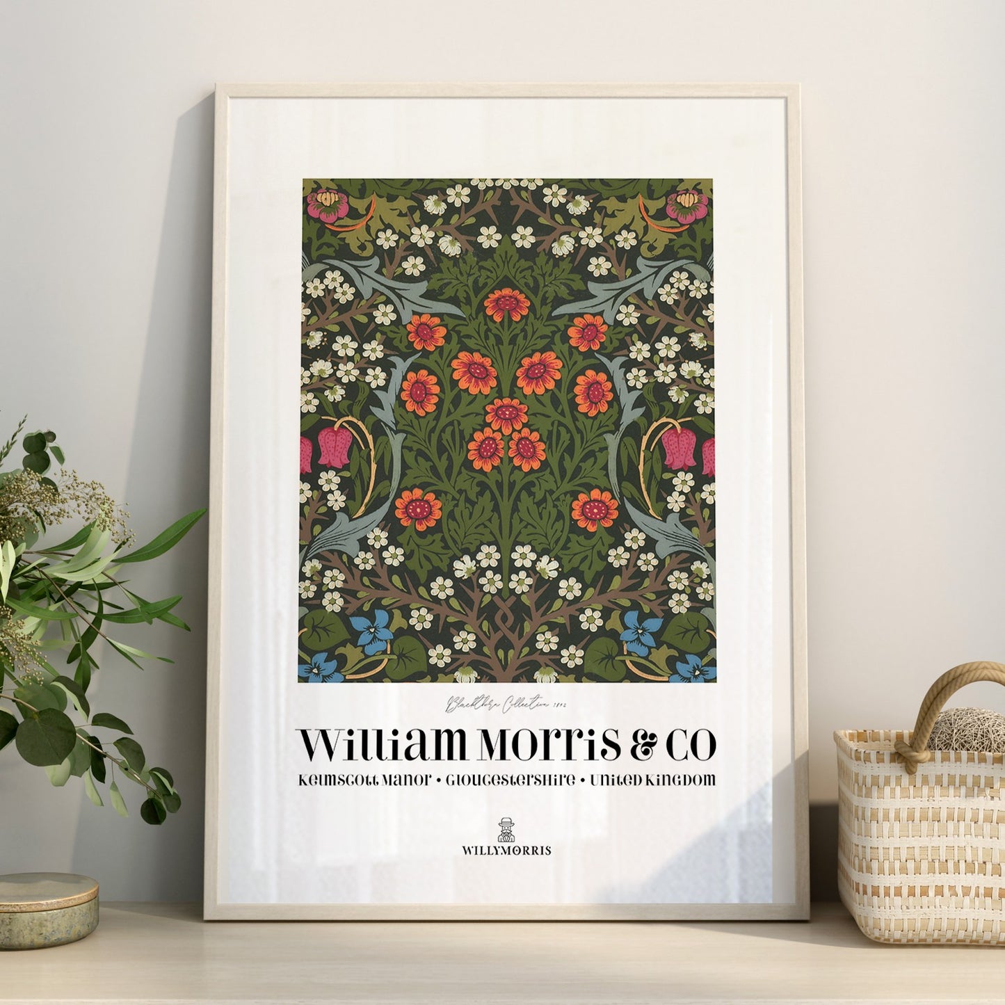 Framed floral pattern poster with 'William Morris & Co' branding on a wall.