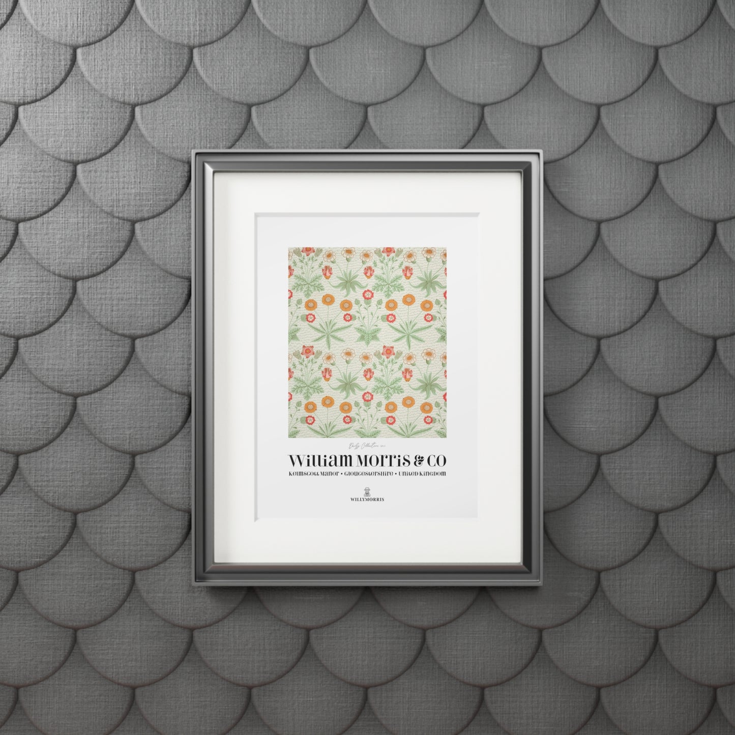 Framed artwork with a floral design and text on a textured gray wall.
